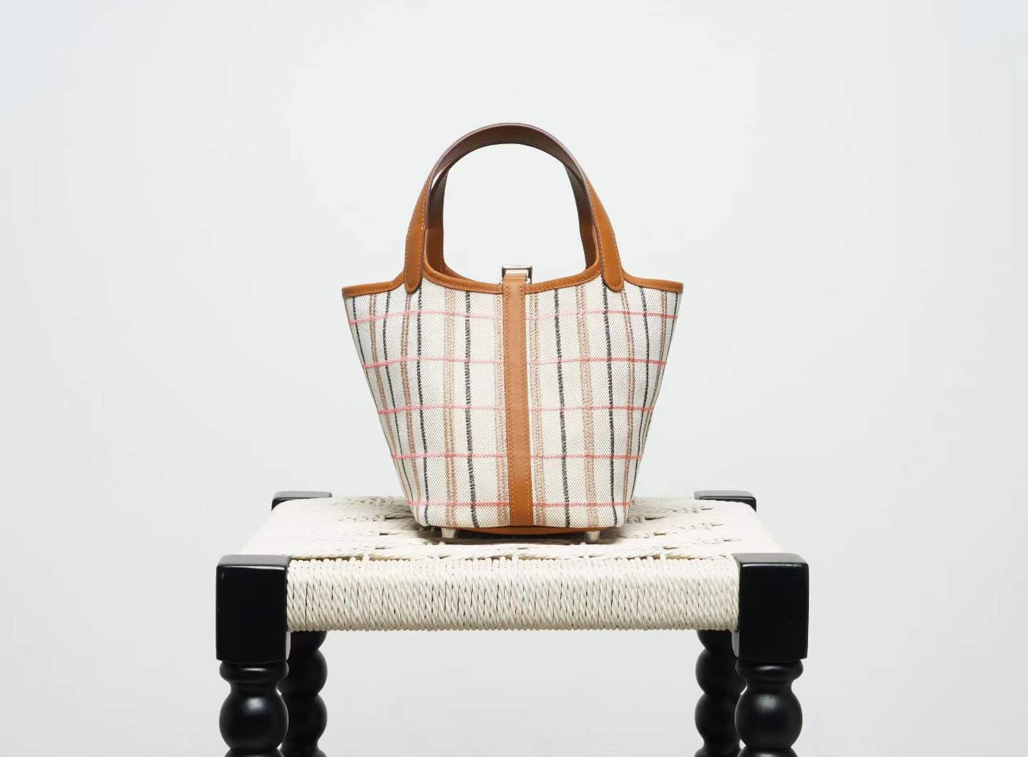 LINJIN LUXURY Picotin Lock 18 style bag in gold leather and plaid canvas, displayed on a natural woven stool against a clean white background - 4