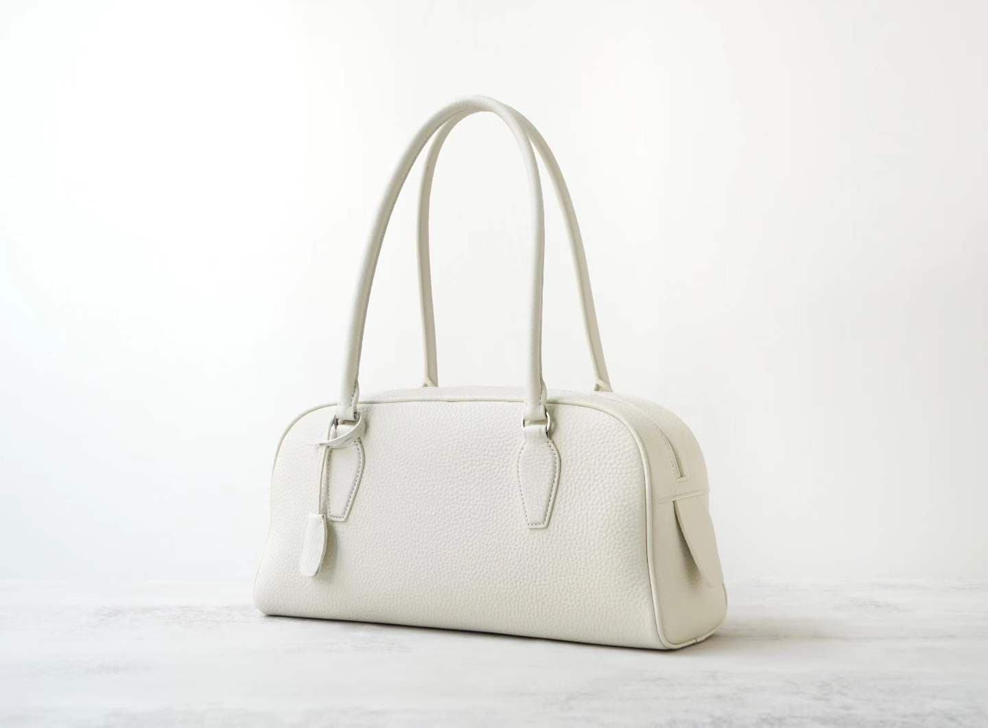 Front view of LINJIN LUXURY Paris-Bombay 35 doctor bag in black Togo leather, featuring an elongated silhouette and tall handles on a white background - 2