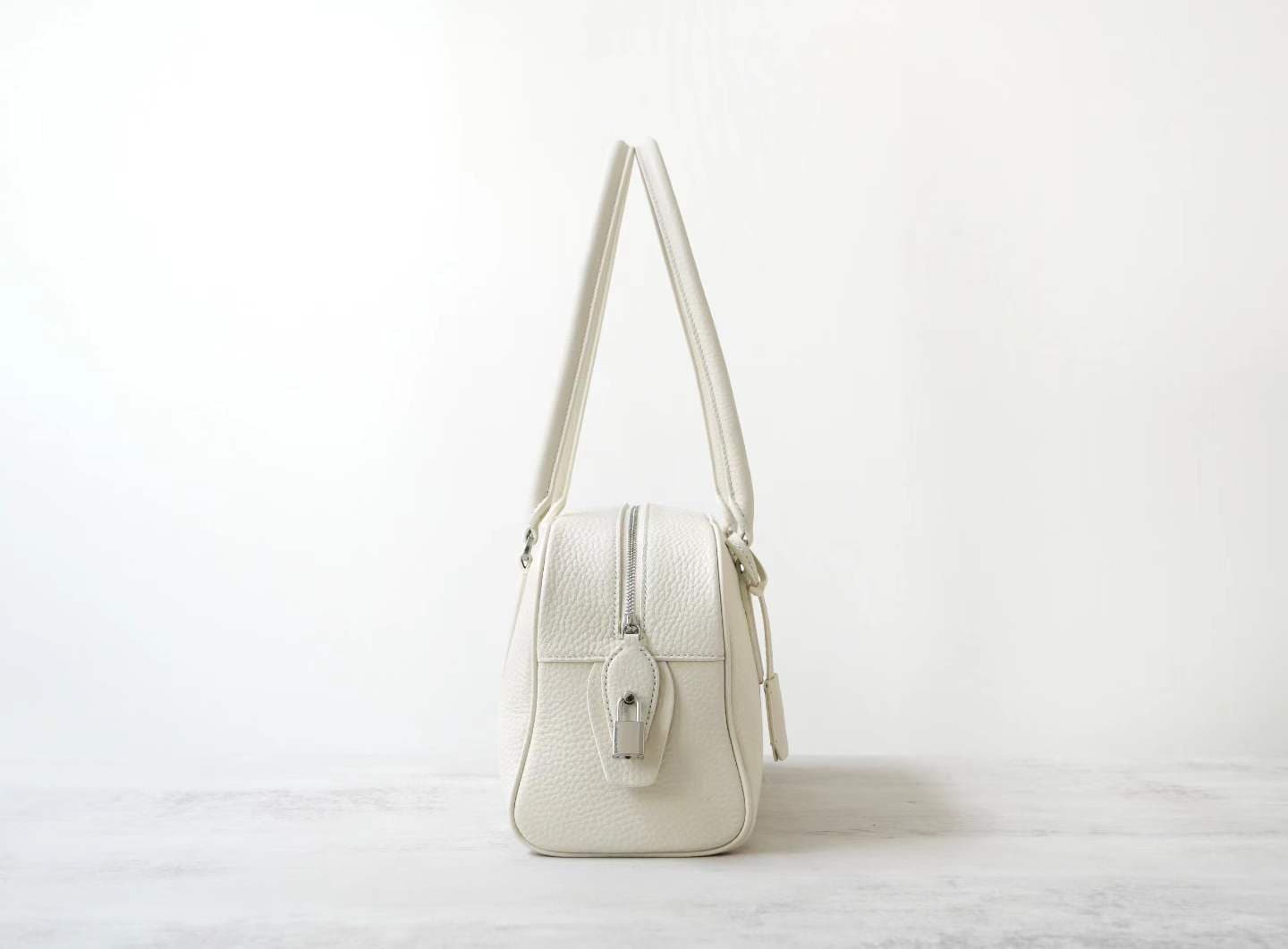 Front view of LINJIN LUXURY Paris-Bombay 35 doctor bag in black Togo leather, featuring an elongated silhouette and tall handles on a white background - 3