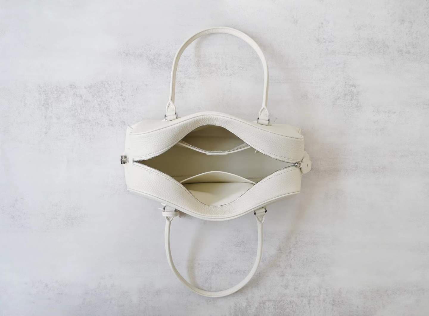Front view of LINJIN LUXURY Paris-Bombay 35 doctor bag in black Togo leather, featuring an elongated silhouette and tall handles on a white background - 6