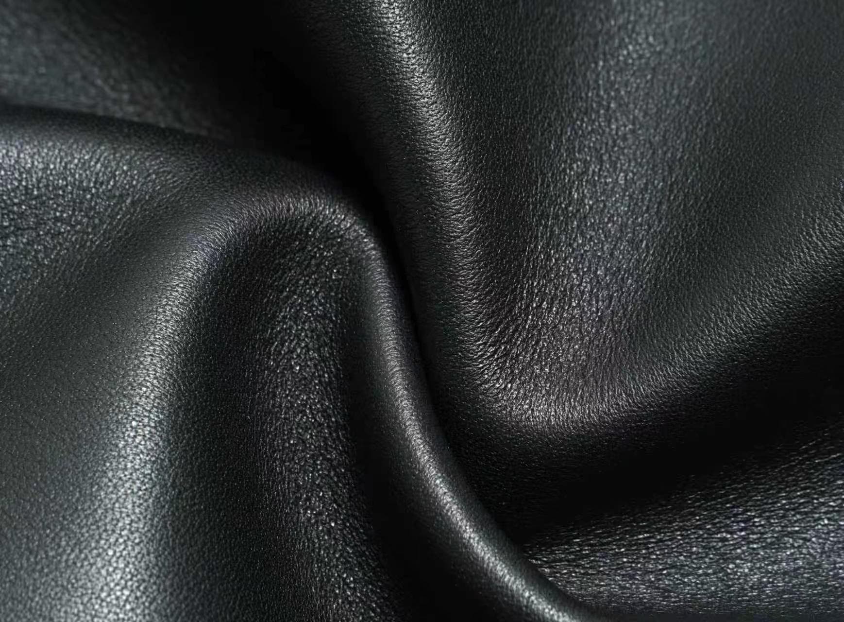 Linjin Luxury polished saddle leather dome bowling bag with natural drape and soft fold texture, dual rolled top handles, structured silhouette, on a light grey surface - 5