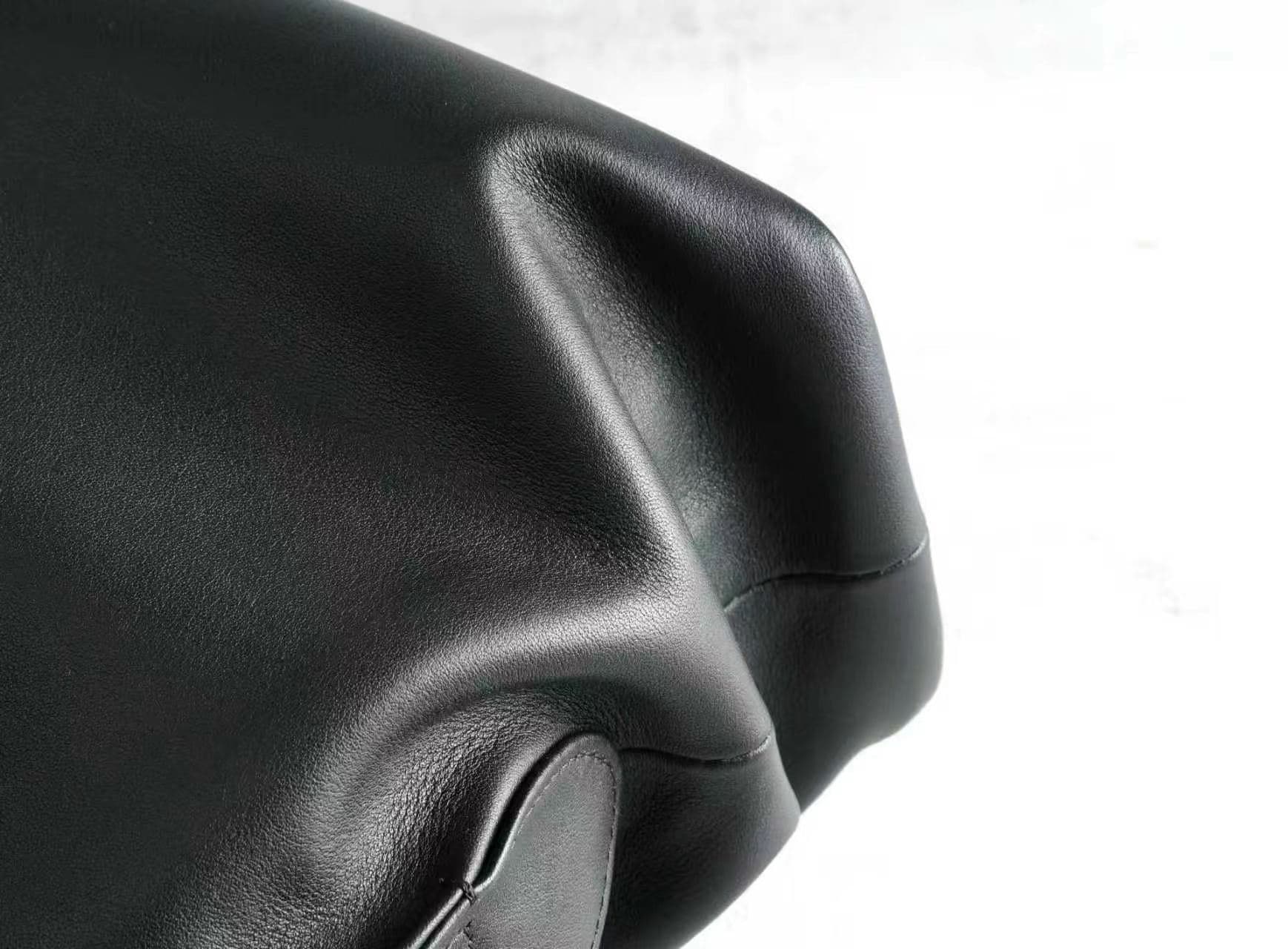 Linjin Luxury polished saddle leather dome bowling bag with natural drape and soft fold texture, dual rolled top handles, structured silhouette, on a light grey surface - 7