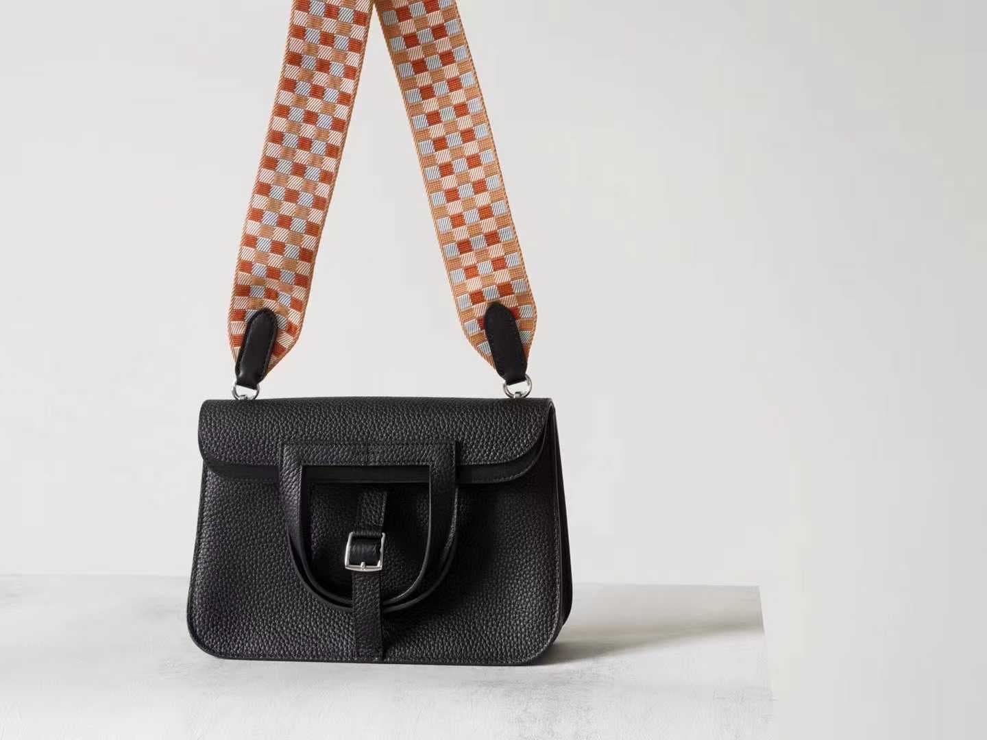 Minimalist black pebbled leather crossbody bag with a front buckle detail and long shoulder strap on a white background | LinJin - 5