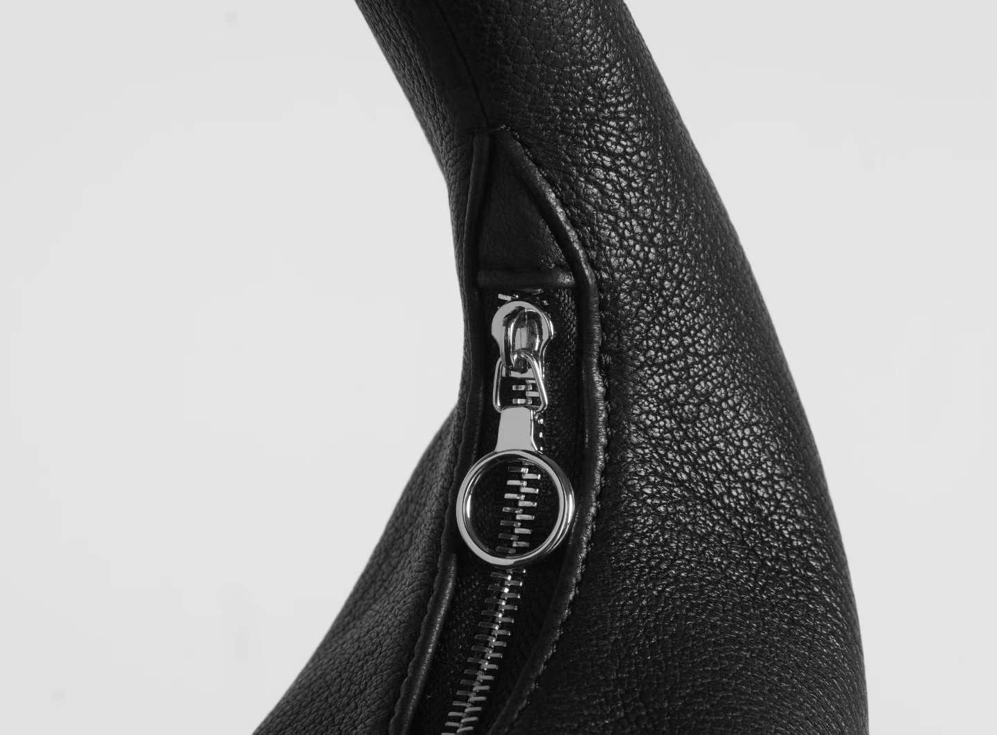 Linjin Luxury black pebbled deerskin lambskin crescent moon bag with single loop top handle and zip closure, minimal silhouette, displayed on a white surface - 4