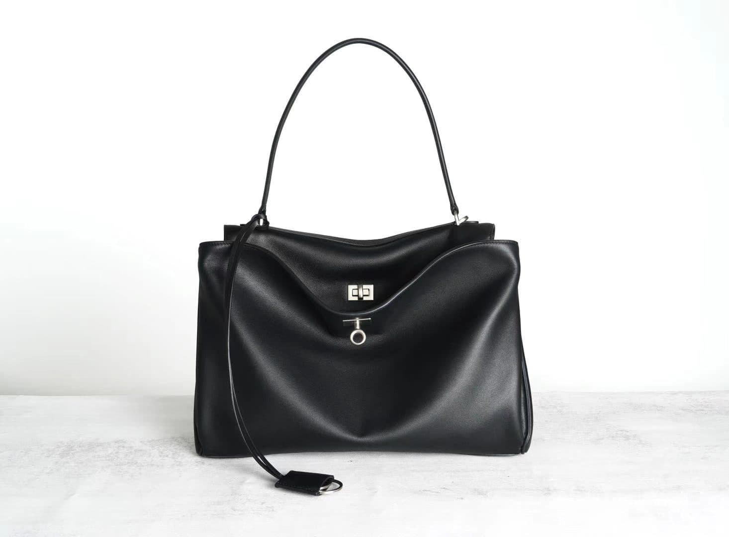 Black genuine leather tote with silver turn-lock, top handle and detachable strap